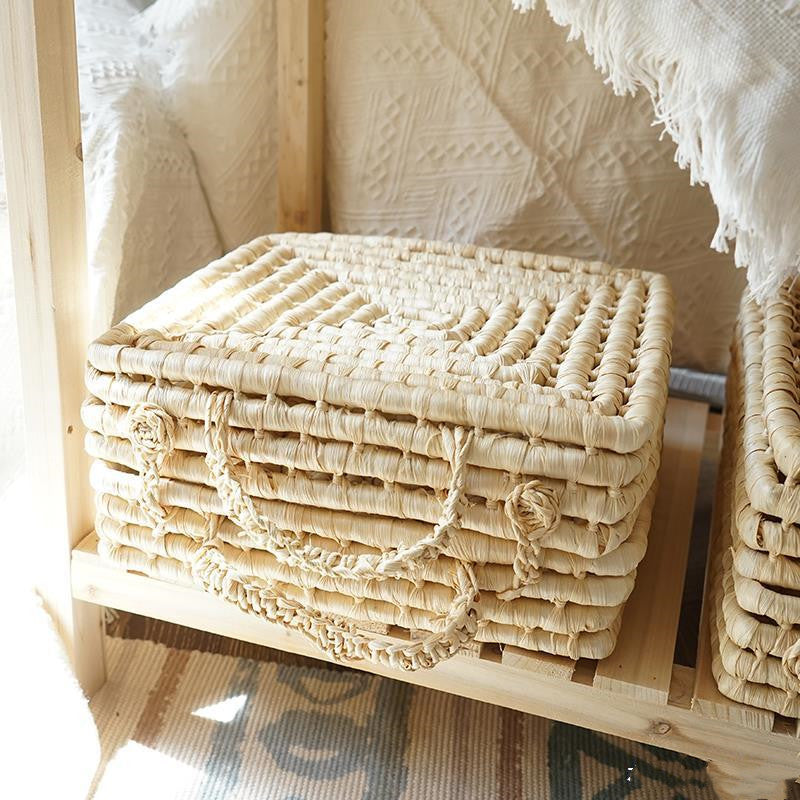 Woven storage box on a wooden surface with a textured white background