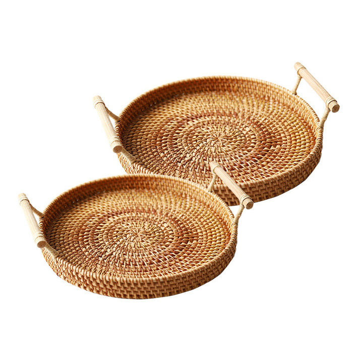 Two woven rattan trays with handles on a white background