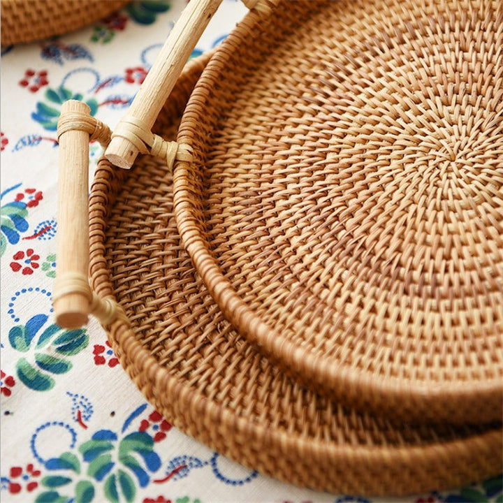 Woven basket with handles on a colorful fabric background
